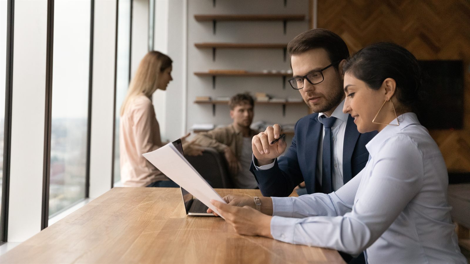 A business owner and CPA reviewing year-end financial statements together
