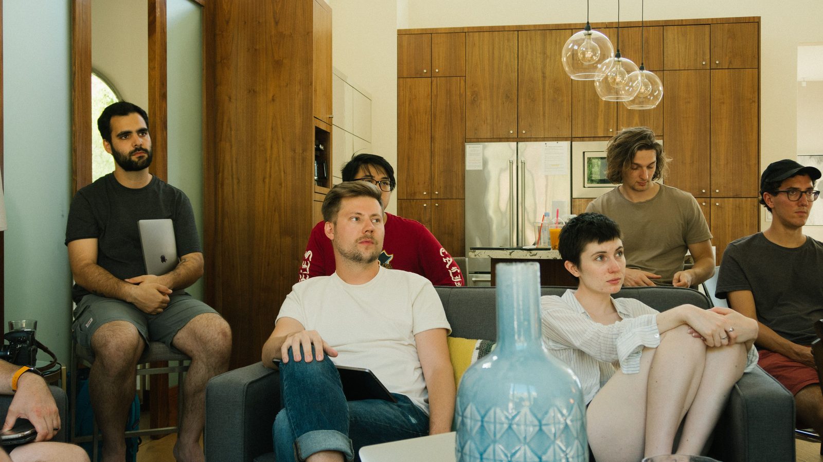 A team gathered with laptops in a casual lounge workspace