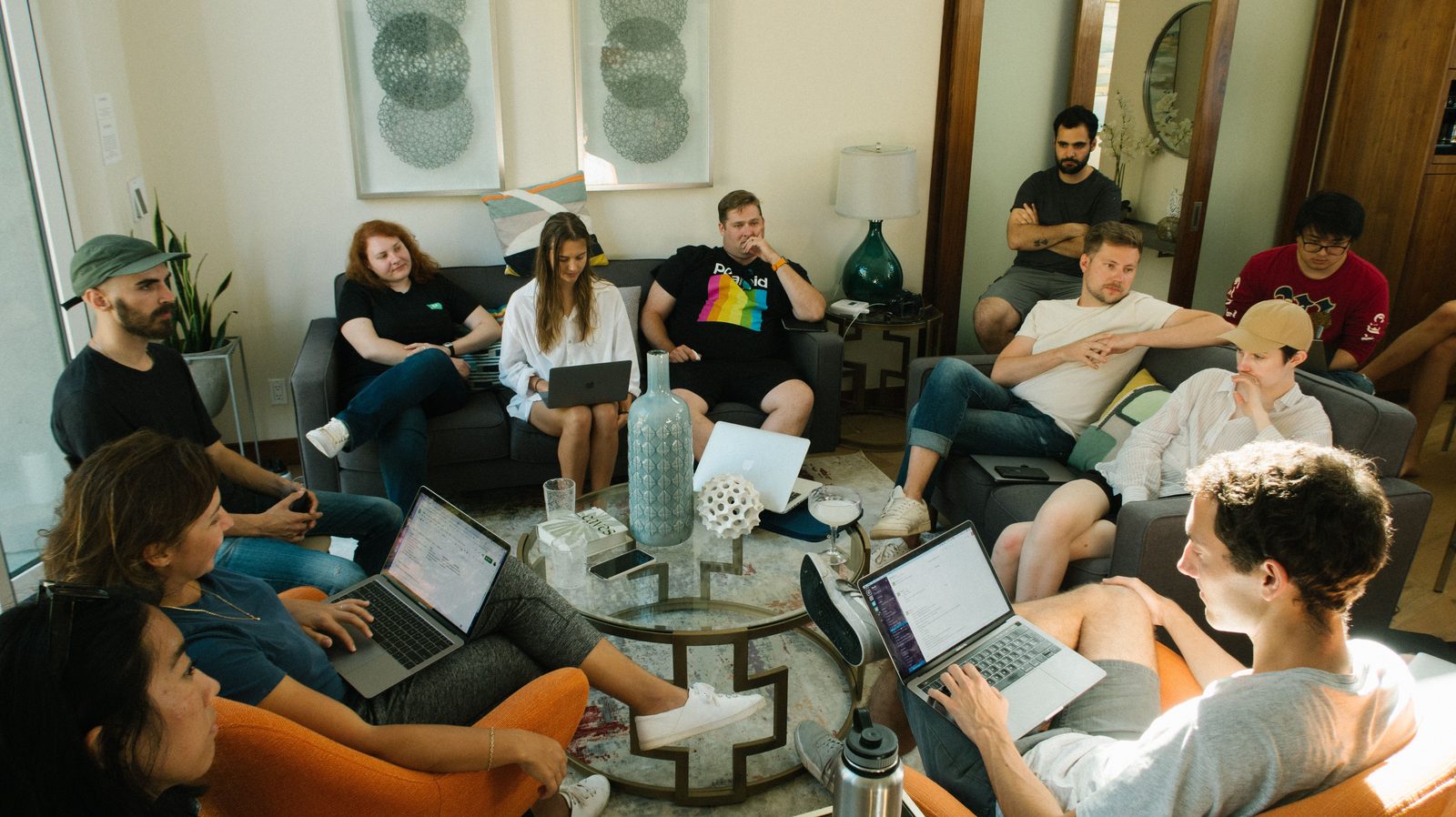 A team working together on laptops in a casual lounge workspace